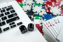 Online,Poker,With,Laptop,Playing,Card,Chips,And,Dice.,Online