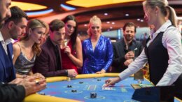 Casino,Baccarat,Gambling,Table:,Female,Croupier,Dealing,Playing,Cards,On